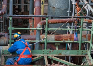 Industrial worker wearing personal protective equipment, the last level of the hierarchy of controls